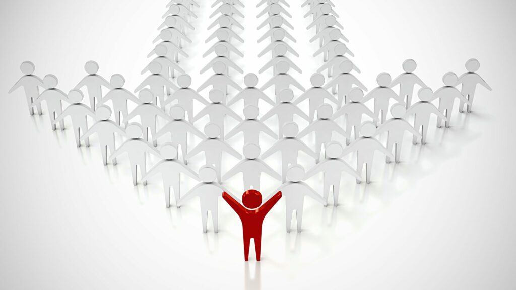 Groupe d’individus avec un leader en rouge symbolisant la position internationale de LaserAddict comme leader du bien-être.